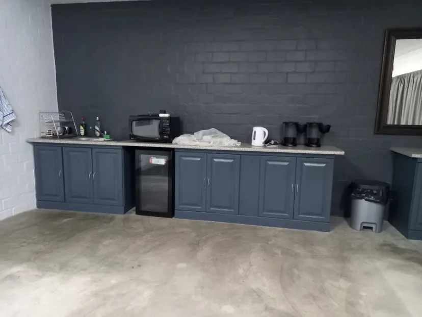 Church kitchen storage cabinets with charcoal-gray paint
